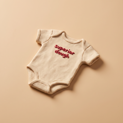 Baby Dough cream organic cotton baby bodysuit, claymation product shot